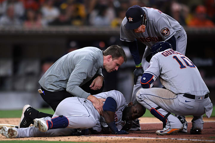 Hoston Astros player being evaluated by training staff