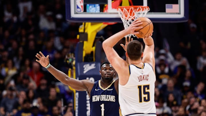  Denver Nuggets center Nikola Jokic (15) attempts a shot as New Orleans Pelicans forward Zion Williamson (1) guards in the first quarter at Ball Arena. Mandatory Credit: Isaiah J. Downing-Imagn Images