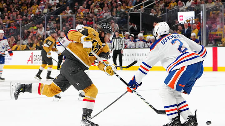 Vegas Golden Knights center William Karlsson (71) shoots against the stick of Edmonton Oilers defenseman Evan Bouchard (2)