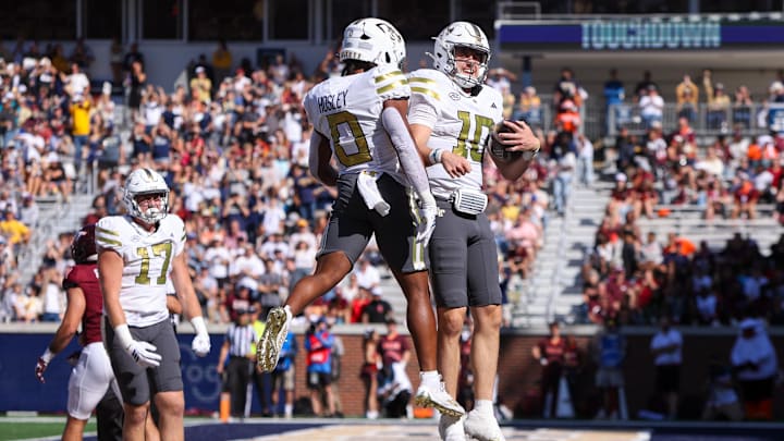 Oct 11, 2025; Atlanta, Georgia, USA; Georgia Tech Yellow Jackets quarterback Haynes King (10) celebrates with running back Malachi Hosley (0) after a touchdown against the Virginia Tech Hokies in the first quarter at Bobby Dodd Stadium at Hyundai Field. Mandatory Credit: Brett Davis-Imagn Images
