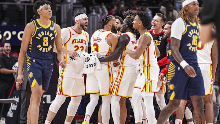 Oct 8, 2024; Atlanta, Georgia, USA; Atlanta Hawks players react with guard Seth Lundy (3) after he made a three point shot against the Indiana Pacers with less than a second remaining in the second half at State Farm Arena. Mandatory Credit: Dale Zanine-Imagn Images