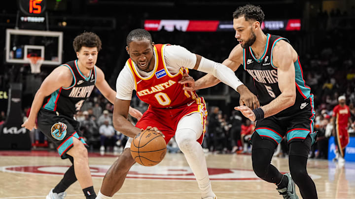 Mar 23, 2026; Atlanta, Georgia, USA; Atlanta Hawks forward Jonathan Kuminga (0) dribbles guarded by Memphis Grizzlies forward Tyler Burton (5) during the second half at State Farm Arena. Mandatory Credit: Dale Zanine-Imagn Images