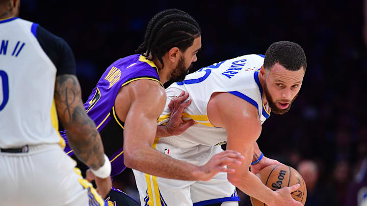 Feb 6, 2025; Los Angeles, California, USA; Golden State Warriors guard Stephen Curry (30) controls the ball against Los Angeles Lakers guard Gabe Vincent (7) during the second half at Crypto.com Arena. Mandatory Credit: Gary A. Vasquez-Imagn Images