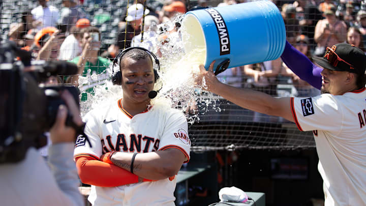 San Francisco Giants shortstop Willy Adames (right) douses teammate Rafael Devers following their victory over the Boston Red Sox at Oracle Park.