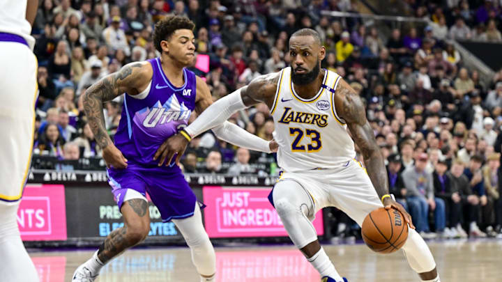 Dec 1, 2024; Salt Lake City, Utah, USA; Los Angeles Lakers forward LeBron James (23) drives towards the basket around Utah Jazz guard Keyonte George (3) during the second half at the Delta Center. Mandatory Credit: Christopher Creveling-Imagn Images