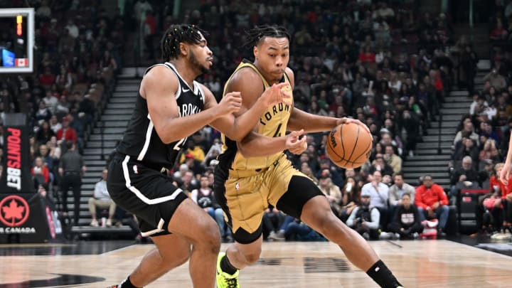 Feb 22, 2024; Toronto, Ontario, CAN;  Toronto Raptors forward Scottie Barnes (24) dribbles the ball past Brooklyn Nets guard Cam Thomas (24) in the first half at Scotiabank Arena. Mandatory Credit: Dan Hamilton-USA TODAY Sports