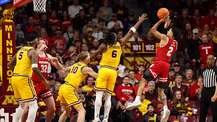 Jan 13, 2026; Minneapolis, Minnesota, USA; Wisconsin Badgers guard Nick Boyd (2) shoots over Minnesota Golden Gophers guard Langston Reynolds (6) during the first half at Williams Arena. Mandatory Credit: Matt Krohn-Imagn Images