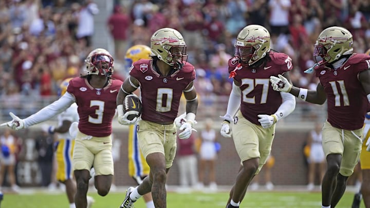 Oct 11, 2025; Tallahassee, Florida, USA; Florida State Seminoles safety Earl Little Jr. (0), defensive back Ashlynd Barker (27), defensive back Edwin Joseph (3), and defensive back Ja'Bril Rawls (11) celebrate after an interception during the first half of the game against the Pittsburgh Panthers at Doak S. Campbell Stadium. Mandatory Credit: Melina Myers-Imagn Images