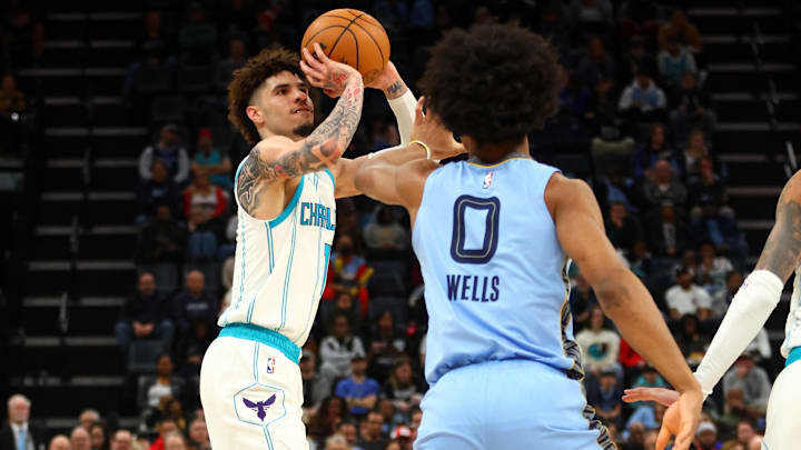 Jan 22, 2025; Memphis, Tennessee, USA; Charlotte Hornets guard LaMelo Ball (1) shoots for three as Memphis Grizzlies forward Jaylen Wells (0) defends during the second quarter at FedExForum. Mandatory Credit: Petre Thomas-Imagn Images Jan 22, 2025; Memphis, Tennessee, USA; Charlotte Hornets guard LaMelo Ball (1) shoots for three as Memphis Grizzlies forward Jaylen Wells (0) defends during the second quarter at FedExForum. Mandatory Credit: Petre Thomas-Imagn Images