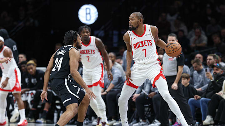 Jan 1, 2026; Brooklyn, New York, USA; Houston Rockets forward Kevin Durant (7) is guarded by Brooklyn Nets guard Cam Thomas (24) during the first half at Barclays Center. Mandatory Credit: Vincent Carchietta-Imagn Images