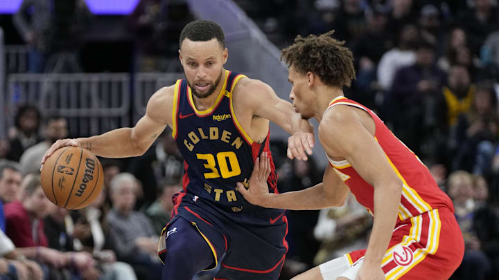 November 20, 2024; San Francisco, California, USA; Golden State Warriors guard Stephen Curry (30) dribbles the basketball against Atlanta Hawks guard Dyson Daniels (5) during the fourth quarter at Chase Center. Mandatory Credit: Kyle Terada-Imagn Images
