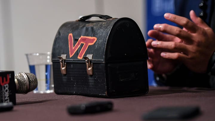Virginia Tech lineman Josh Fuga answers a question near his \"lunch pail\" at a breakout session during the ACC Kickoff Media Days event in downtown Charlotte, N.C. Wednesday, July 26, 2023.