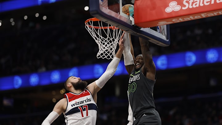 Jan 13, 2025; Washington, District of Columbia, USA; Minnesota Timberwolves forward Julius Randle (30) dunks the ball as Washington Wizards guard Bilal Coulibaly (0) and Wizards center Jonas Valanciunas (17) defend in the fourth quarter at Capital One Arena. Mandatory Credit: Geoff Burke-Imagn Images
