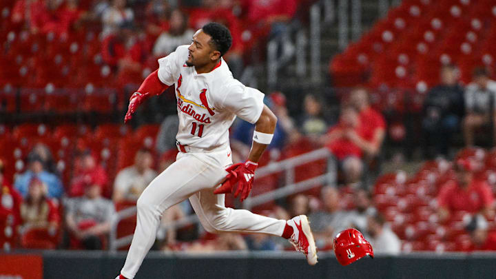 May 4, 2026; St. Louis, Missouri, USA; St. Louis Cardinals center fielder Victor Scott II (11) loses his helmet as he runs after hitting a double against the Milwaukee Brewers during the eighth inning at Busch Stadium. Mandatory Credit: Jeff Curry-Imagn Images