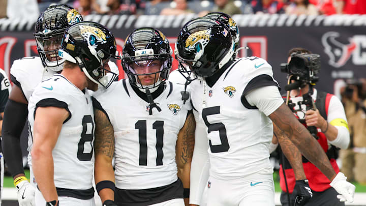 Nov 9, 2025; Houston, Texas, USA; Jacksonville Jaguars wide receiver Austin Trammell (81) and wide receiver Dyami Brown (5) react with wide receiver Parker Washington (11) after a 72-yard punt return for a touchdown against the Houston Texans during the first half at NRG Stadium. Mandatory Credit: Thomas Shea-Imagn Images