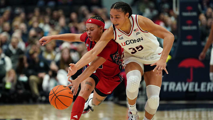 Jan 7, 2026; Hartford, Connecticut, USA; UConn Huskies guard Azzi Fudd (35) and St. John's Red Storm guard Shaulana Wagner (8) work for the loose ball in the first half at PeoplesBank Arena. Mandatory Credit: David Butler II-Imagn Images