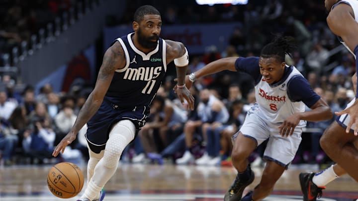 Dec 5, 2024; Washington, District of Columbia, USA; Dallas Mavericks guard Kyrie Irving (11) drives to the basket as Washington Wizards guard Bub Carrington (8) chases in the second quarter at Capital One Arena. Mandatory Credit: Geoff Burke-Imagn Images