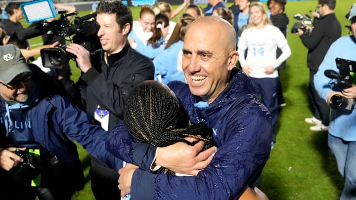 Dec 9, 2024; Cary, NC, USA;North Carolina head coach Damon Nahas hugs forward Asha Means (39) after winning the national championship at WakeMed Soccer Park. Mandatory Credit: Bob Donnan-Imagn Images