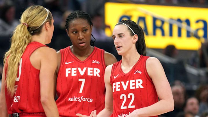 Jun 19, 2025; San Francisco, California, USA; Indiana Fever guard Caitlin Clark (22) talks to guard Lexie Hull (left) and forward Aliyah Boston (7) during the third quarter against the Golden State Valkyries at Chase Center. Mandatory Credit: Darren Yamashita-Imagn Images