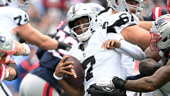 Sep 7, 2025; Foxborough, Massachusetts, USA; Las Vegas Raiders quarterback Geno Smith (7) is sacked by New England Patriots linebacker Harold Landry III (2) during the first half at Gillette Stadium. Mandatory Credit: Brian Fluharty-Imagn Images