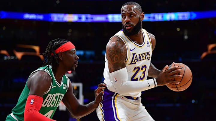 Dec 25, 2023; Los Angeles, California, USA; Los Angeles Lakers forward LeBron James (23) controls the ball against Boston Celtics guard Jrue Holiday (4) during the first half at Crypto.com Arena. Mandatory Credit: Gary A. Vasquez-Imagn Images