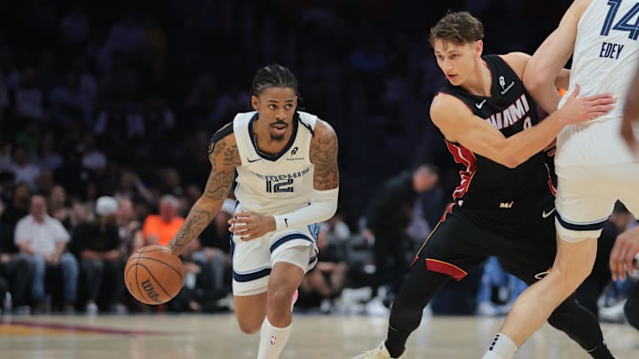 Apr 3, 2025; Miami, Florida, USA; Memphis Grizzlies guard Ja Morant (12) drives to the basket past Miami Heat guard Pelle Larsson (9) during the first quarter at Kaseya Center. Mandatory Credit: Sam Navarro-Imagn Images