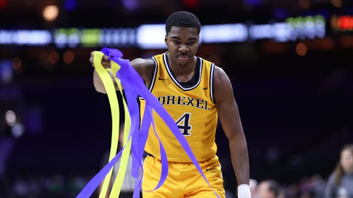 Dec 6, 2025; Philadelphia, PA, USA; Drexel Dragons guard Shane Blakeney (4) gathers streamers after fans tossed them onto the court after a La Salle Explorers score during the first half at Xfinity Mobile Arena. Mandatory Credit: Bill Streicher-Imagn Images