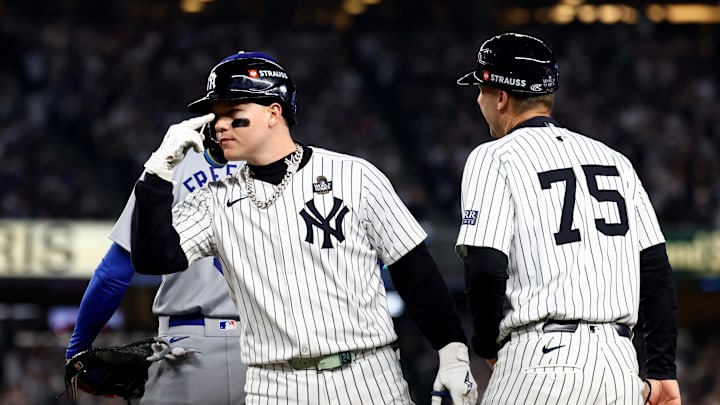 Oct 30, 2024; New York, New York, USA; New York Yankees outfielder Alex Verdugo (24) celebrates with first base coach Travis Chapman (75) after hitting a RBI single during the second inning against the Los Angeles Dodgers in game five of the 2024 MLB World Series at Yankee Stadium. Mandatory Credit: Vincent Carchietta-Imagn Images