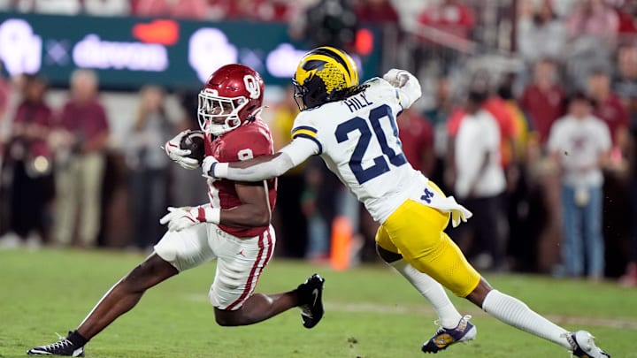Oklahoma's Keontez Lewis (9) looks to get by Michigan's Jyaire Hill (20) 