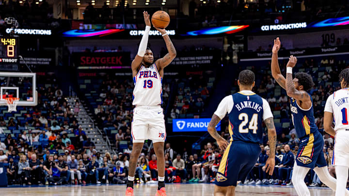 Mar 24, 2025; New Orleans, Louisiana, USA;  Philadelphia 76ers forward Justin Edwards (19) shoots a jump shot against New Orleans Pelicans guard Jordan Hawkins (24) during the first half at Smoothie King Center. Mandatory Credit: Stephen Lew-Imagn Images