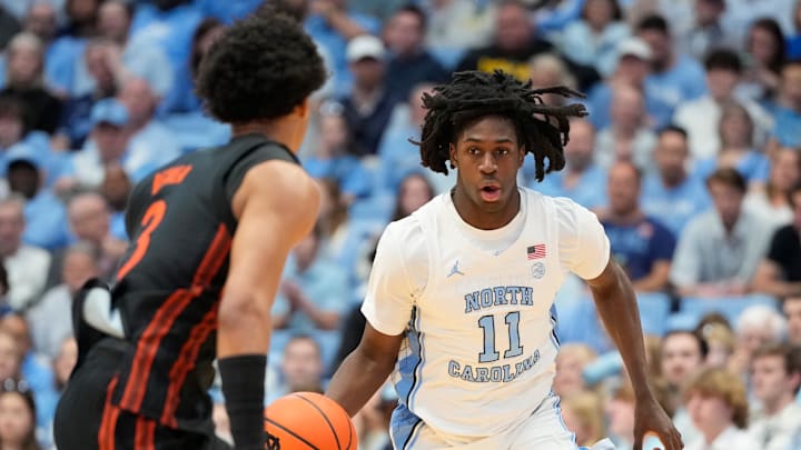 Mar 1, 2025; Chapel Hill, North Carolina, USA;  North Carolina Tar Heels guard Ian Jackson (11) brings the ball up the court as Miami (Fl) Hurricanes guard Jalil Bethea (3) defends in the second half at Dean E. Smith Center. Mandatory Credit: Bob Donnan-Imagn Images
