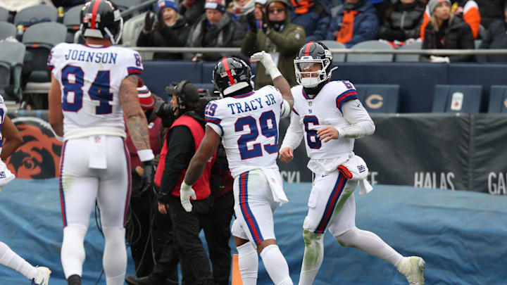Nov 9, 2025; Chicago, Illinois, USA; New York Giants quarterback Jaxson Dart (6) reacts after rushing for a touchdown against the Chicago Bears during the second half at Soldier Field.  