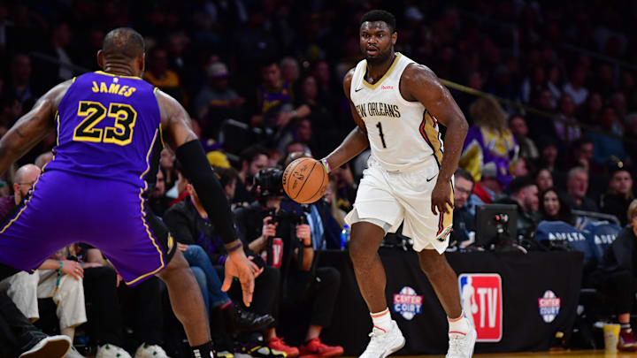 Feb 9, 2024; Los Angeles, California, USA; New Orleans Pelicans forward Zion Williamson (1) moves the ball up court against Los Angeles Lakers forward LeBron James (23) during the second half at Crypto.com Arena. Mandatory Credit: Gary A. Vasquez-Imagn Images