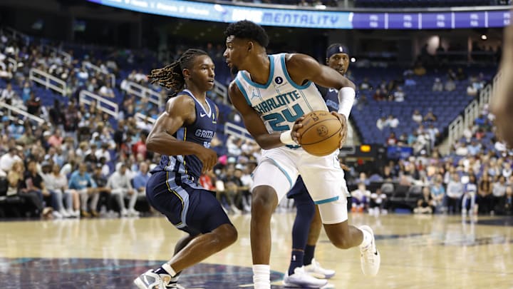 Oct 15, 2025; Greensboro, North Carolina, USA; Charlotte Hornets forward Brandon Miller (24) is guarded by Memphis Grizzlies guard Javon Small (10) during second quarter action at First Horizon Coliseum. Mandatory Credit: Brian Westerholt-Imagn Images