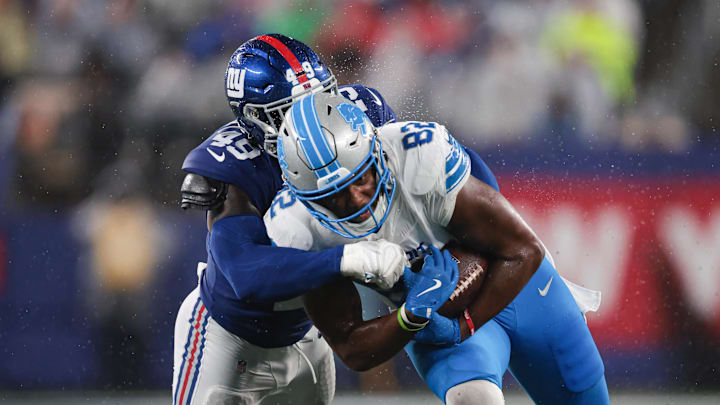 Aug 8, 2024; East Rutherford, New Jersey, USA; Detroit Lions tight end James Mitchell (82) is tackled by New York Giants linebacker Matthew Adams (49) during the first half at MetLife Stadium. Mandatory Credit: Vincent Carchietta-Imagn Images