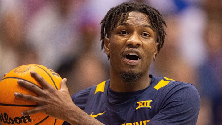West Virginia super-senior Kedrian Johnson (0) yells to a teammate after a possession change during the first half of Saturday s game against Kansas inside Allen Fieldhouse. West Virginia super-senior Kedrian Johnson (0) yells to a teammate after a possession change during the first half of Saturday s game against Kansas inside Allen Fieldhouse.