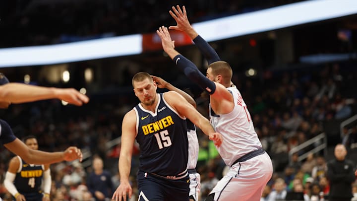 Dec 7, 2024; Washington, District of Columbia, USA; Denver Nuggets center Nikola Jokic (15) drives to the basket as Washington Wizards center Jonas Valanciunas (17) defends in the second quarter at Capital One Arena. Mandatory Credit: Geoff Burke-Imagn Images