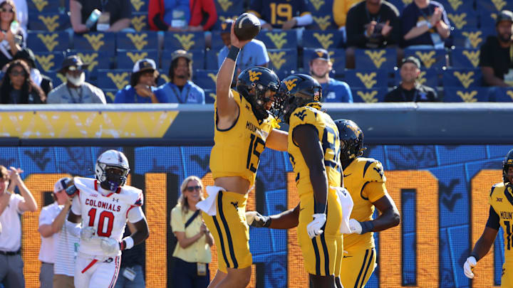 West Virginia University quarterback Scotty Fox Jr. celebrates his 59-yard touchdown run with tight end Greg Genross.