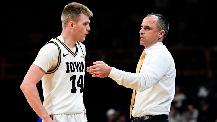 Iowa Hawkeyes guard Bennett Stirtz (14) and head coach Ben McCollum