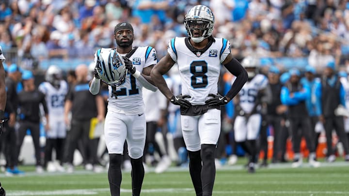Sep 29, 2024; Charlotte, North Carolina, USA; Carolina Panthers safety Nick Scott (21) and cornerback Jaycee Horn (8) take the field during 1st quarter against the Cincinnati Bengals at Bank of America Stadium. Mandatory Credit: Jim Dedmon-Imagn Images