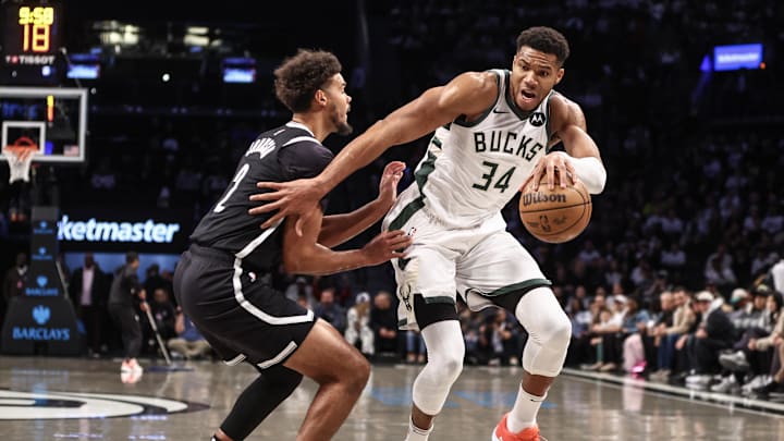 Oct 27, 2024; Brooklyn, New York, USA;  Milwaukee Bucks forward Giannis Antetokounmpo (34) looks to drive past Brooklyn Nets forward Cameron Johnson (2) in the first quarter at Barclays Center. Mandatory Credit: Wendell Cruz-Imagn Images