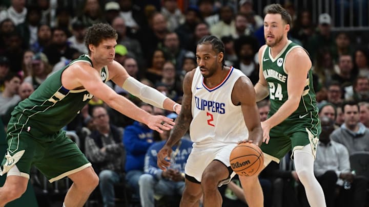 Mar 4, 2024; Milwaukee, Wisconsin, USA;  Los Angeles Clippers forward Kawhi Leonard (2) gets pressure from Milwaukee Bucks center Brook Lopez (11) and guard Pat Connaughton (24) in the third quarter at Fiserv Forum. Mandatory Credit: Benny Sieu-Imagn Images
