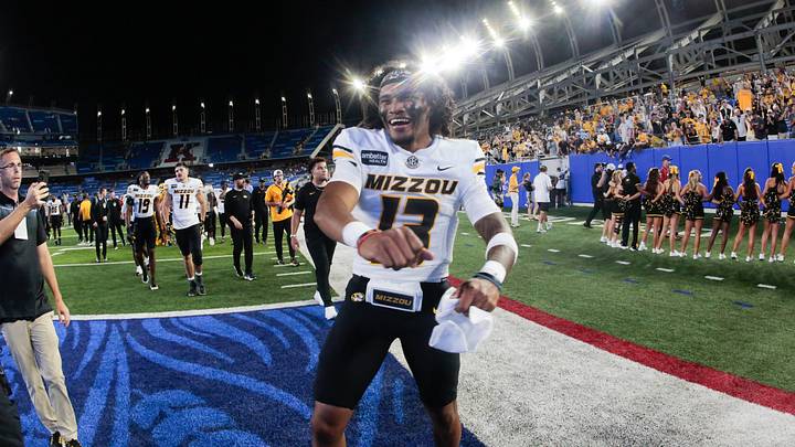 Missouri Tigers quarterback Austin Simmons (13) celebrates their win over Kansas Jayhawks during the game inside David Booth Kansas Memorial Stadium on Sept. 11, 2026. Missouri Tigers quarterback Austin Simmons (13) celebrates their win over Kansas Jayhawks during the game inside David Booth Kansas Memorial Stadium on Sept. 11, 2026.