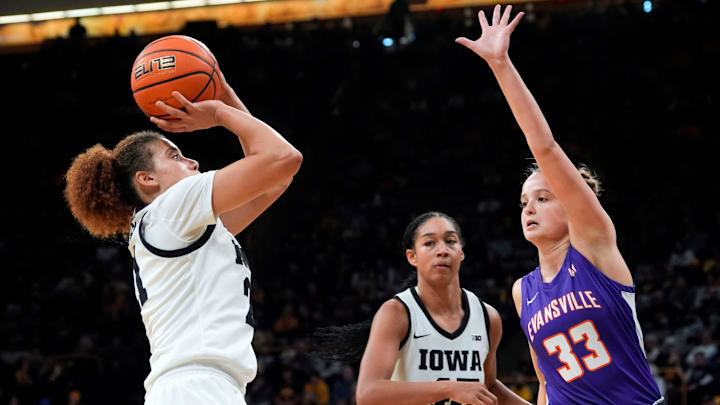Iowa guard Emely Rodriguez (21) shoots against Evansville guard Logan Luebbers Palmer (33) Nov. 9, 2025 during a women’s basketball game at Carver-Hawkeye Arena in Iowa City, Iowa. Iowa guard Emely Rodriguez (21) shoots against Evansville guard Logan Luebbers Palmer (33) Nov. 9, 2025 during a women’s basketball game at Carver-Hawkeye Arena in Iowa City, Iowa.