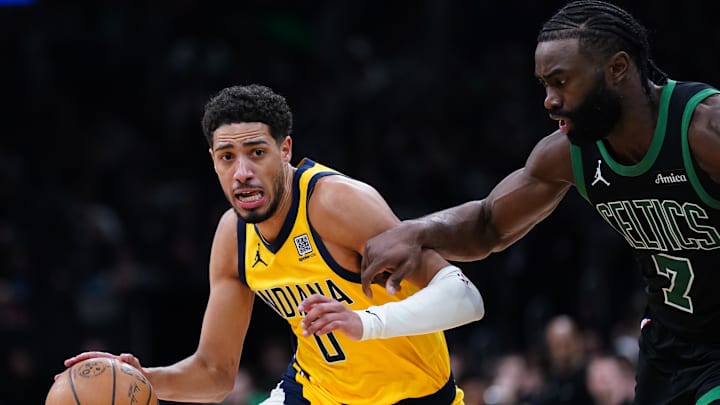 Dec 27, 2024; Boston, Massachusetts, USA; Indiana Pacers guard Tyrese Haliburton (0) drives the ball against Boston Celtics guard Jaylen Brown (7) in the second half at TD Garden. Mandatory Credit: David Butler II-Imagn Images