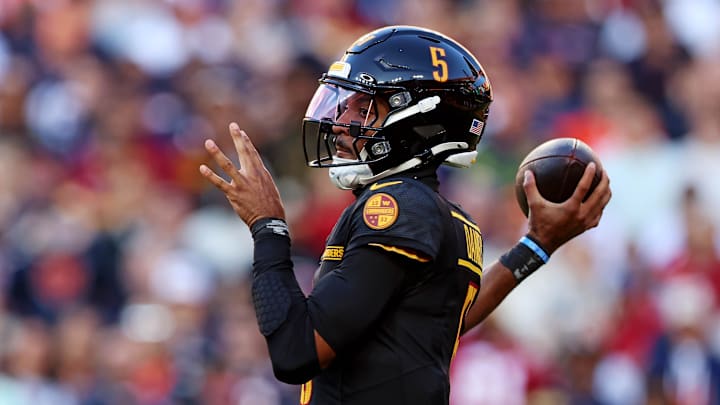 Oct 27, 2024; Landover, Maryland, USA; Washington Commanders quarterback Jayden Daniels (5) throws a pass during the first quarter against the Chicago Bears at Commanders Field. Mandatory Credit: Peter Casey-Imagn Images
