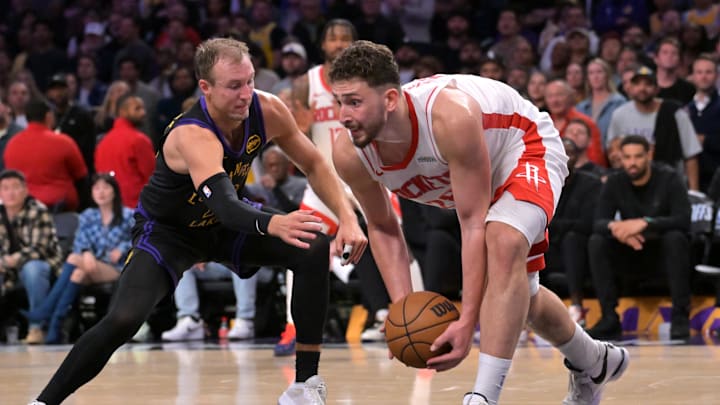 Apr 21, 2026; Los Angeles, California, USA; Los Angeles Lakers guard Luke Kennard (10) defends Houston Rockets center Alperen Sengun (28) after a reoubnd during the second half of game two of the first round of the 2026 NBA Playoffs at Crypto.com Arena. Mandatory Credit: Jayne Kamin-Oncea-Imagn Images