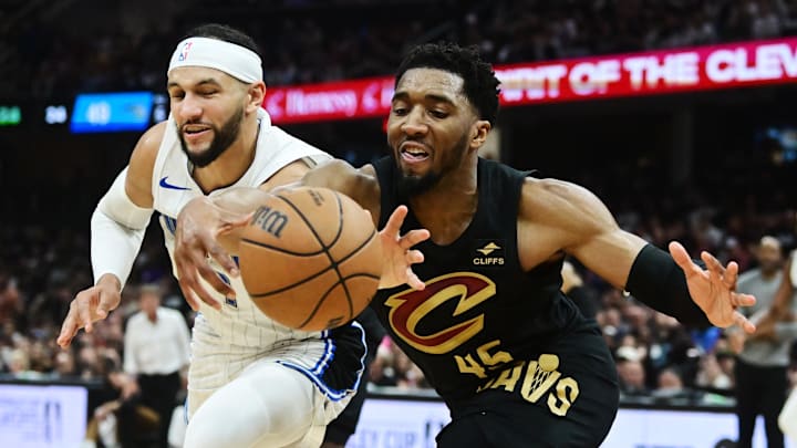 Cleveland Cavaliers guard Donovan Mitchell (45) goes for a loose ball against Orlando Magic guard Jalen Suggs (4) during the first half in game seven of the first round for the 2024 NBA playoffs at Rocket Mortgage FieldHouse.