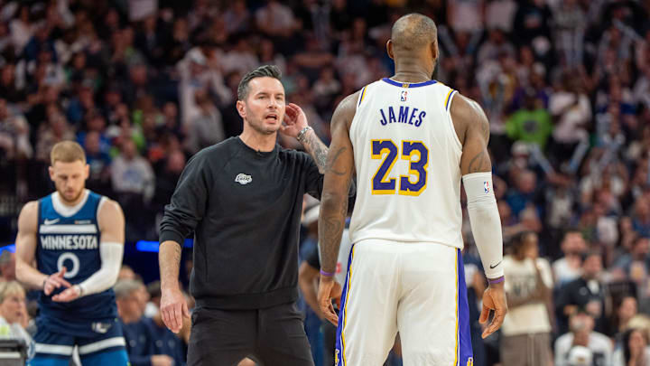 Apr 27, 2025; Minneapolis, Minnesota, USA; Los Angeles Lakers head coach JJ Redick talks with forward LeBron James (23) in the fourth quarter against the Minnesota Timberwolves during game four of first round for the 2025 NBA Playoffs at Target Center. Mandatory Credit: Matt Blewett-Imagn Images