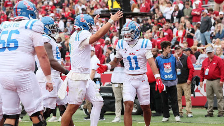 Nov 2, 2024; Fayetteville, Arkansas, USA; Ole Miss Rebels wide receiver Jordan Watkins (11) celebrates with quarterback Jaxson Dart (2) after catching a pass for a touchdown in the second quarter against the Arkansas Razorbacks at Donald W. Reynolds Razorback Stadium. Mandatory Credit: Nelson Chenault-Imagn Images